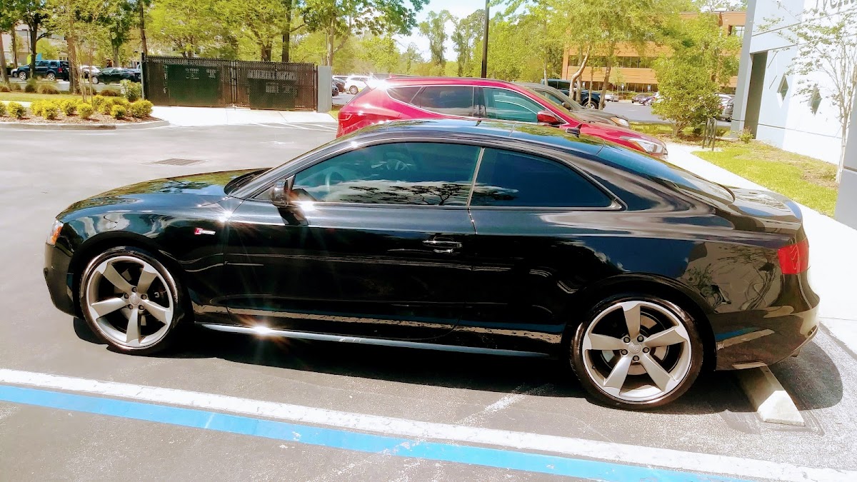 Black Audi coupe with a deep glossy finish after a full detail